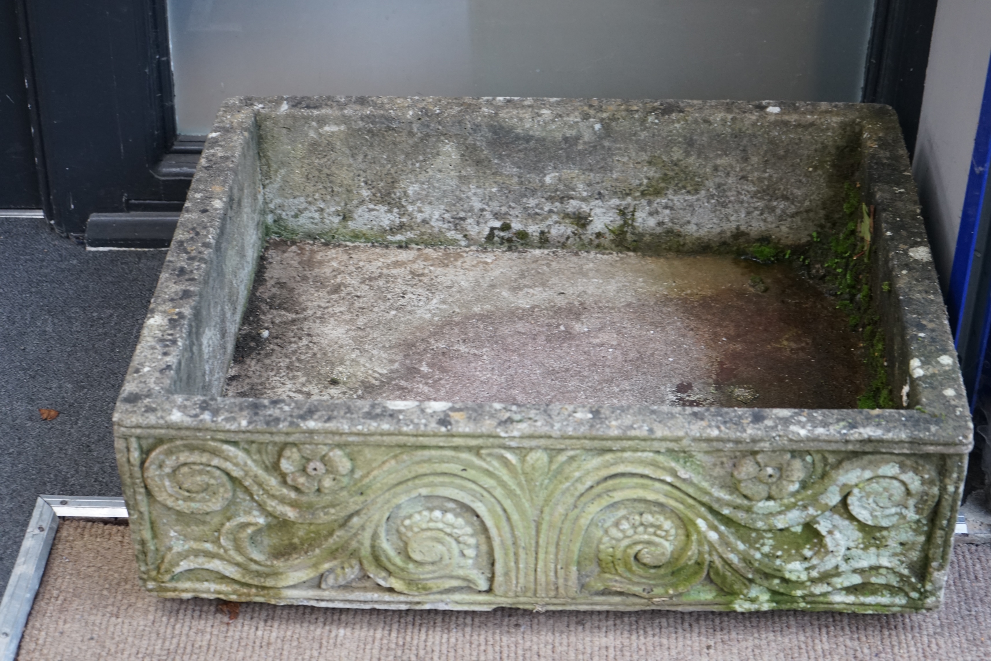 A rectangular reconstituted stone garden trough